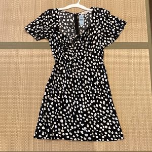 Black and white polka dot dress with peephole in front of very sexy on